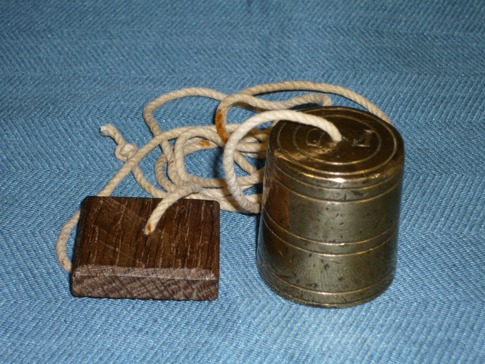 Antiques of bronze plumb bob with walnut trunk