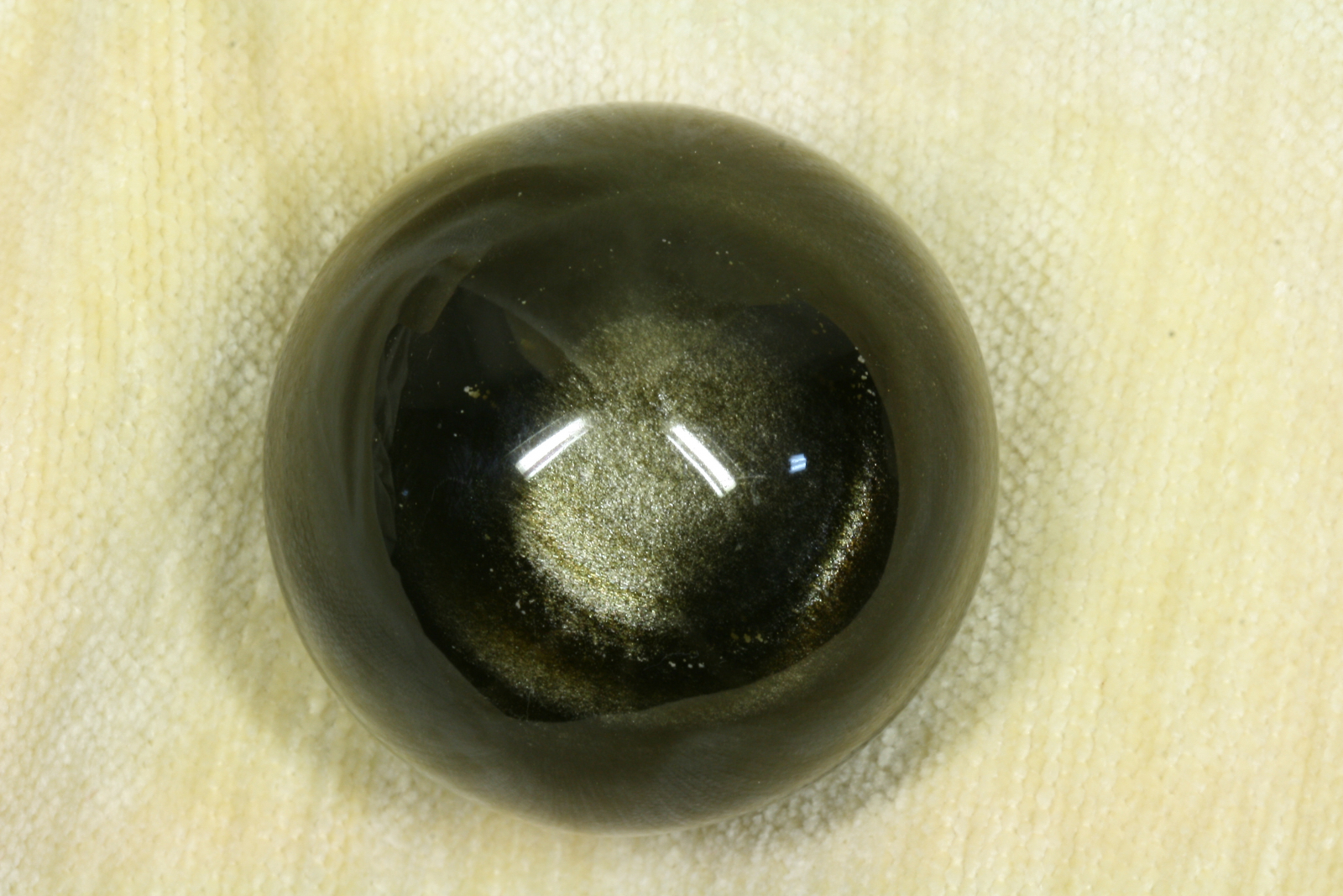 Antiques of black stone ball with goldengreen shine