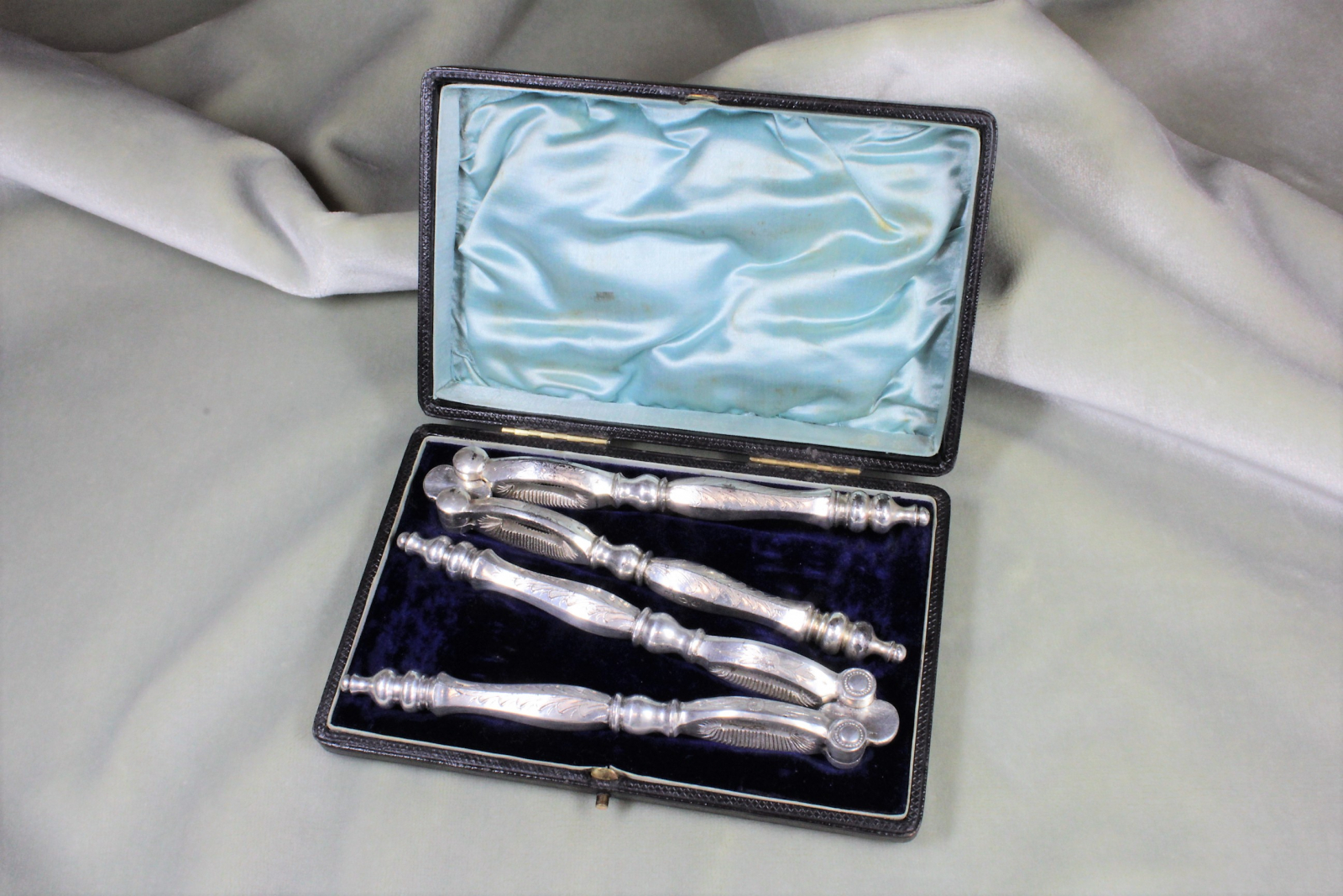 Antiques of pair silver nutcracker with box contrasts