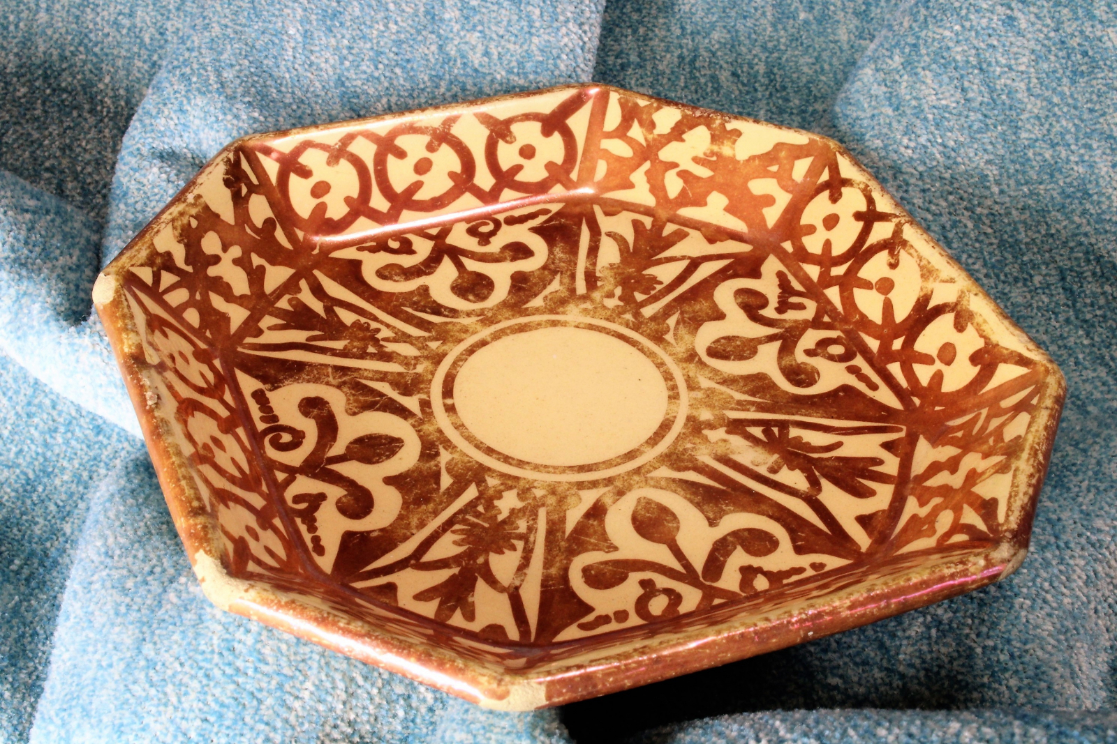 Antiques of octagonal earthenware plate with reflections