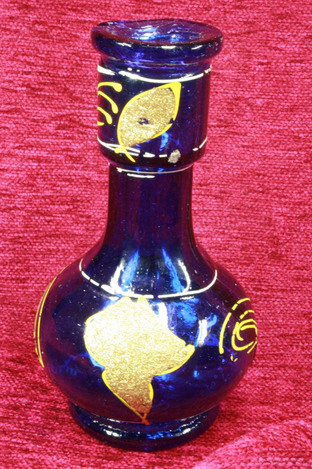 Antiques of small blue glass vase painted