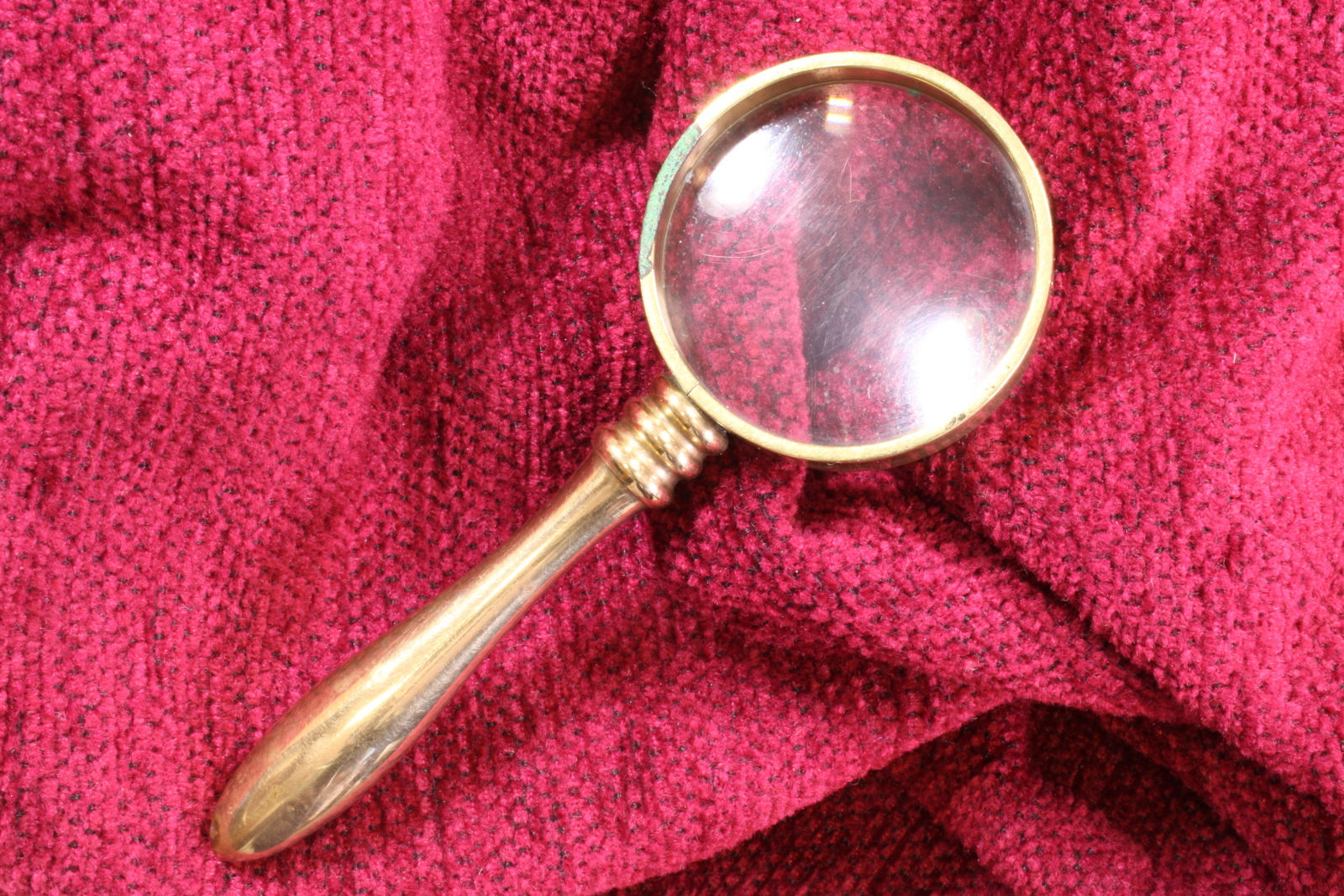 Antiques of miniature brass magnifying glass with handle