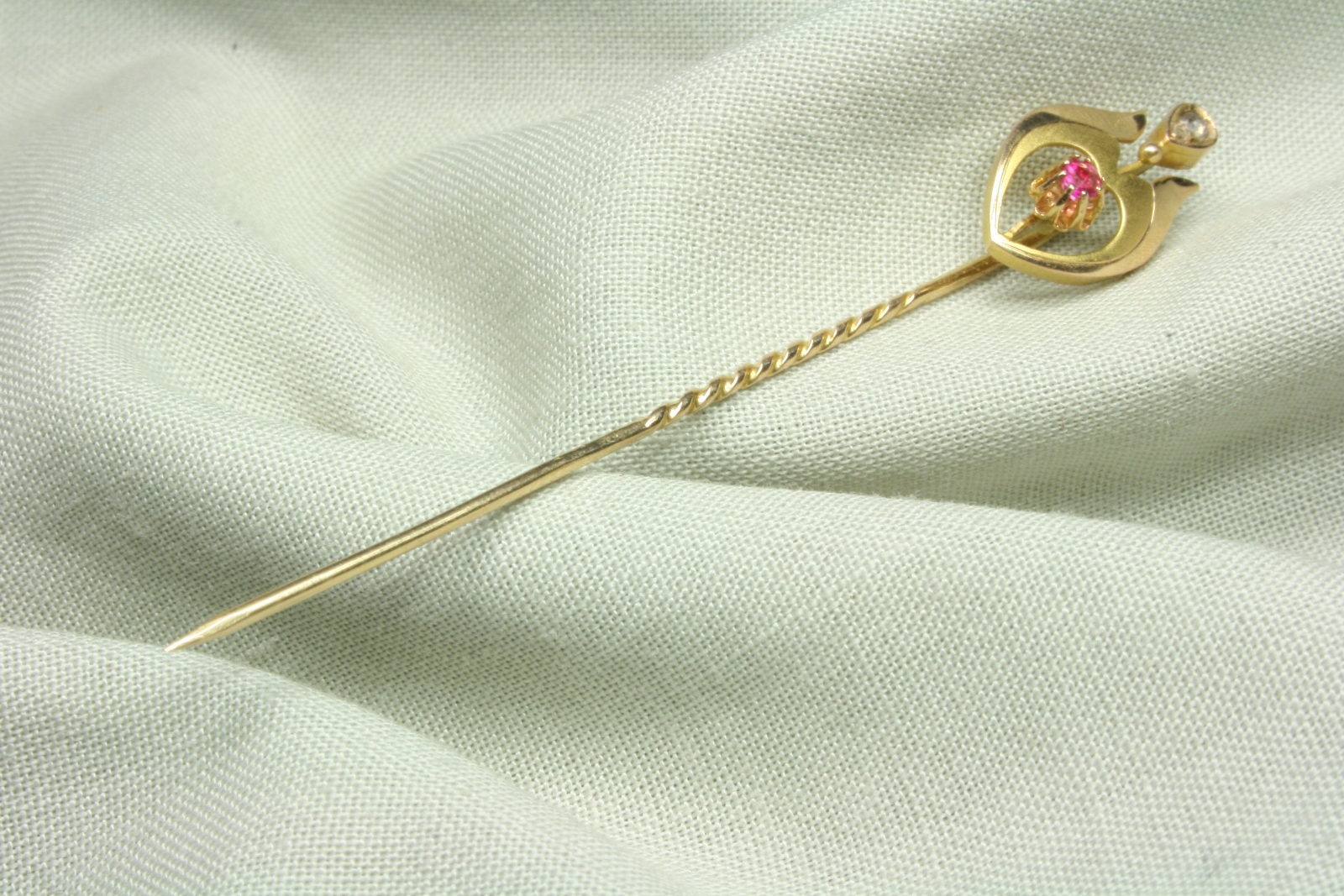 Antiques of gold pin with ruby