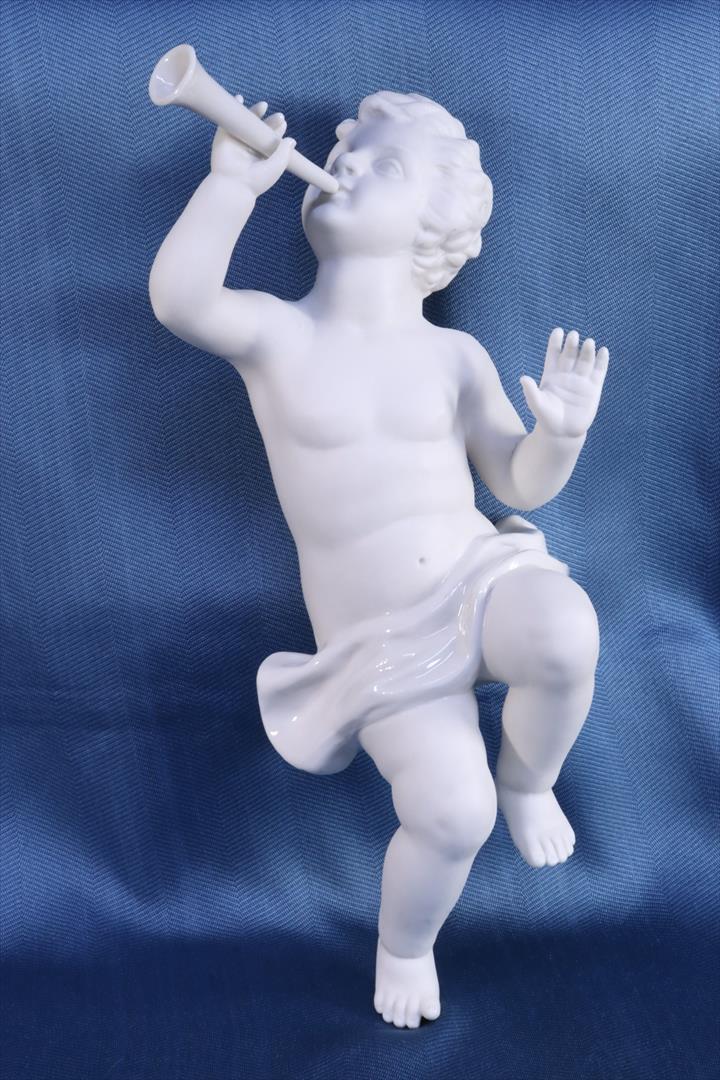 Antiques of biscuit sculpture boy sitting with trumpet