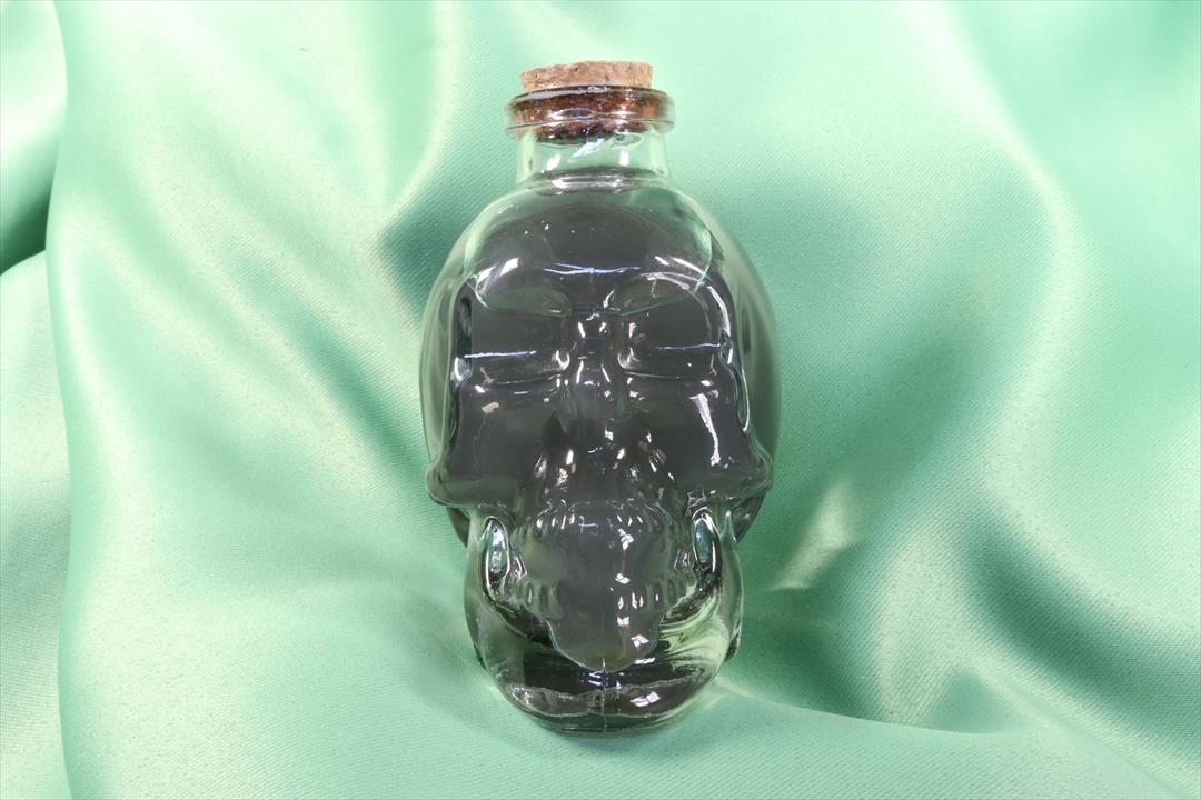 Antiques of glass skull with water and herbs