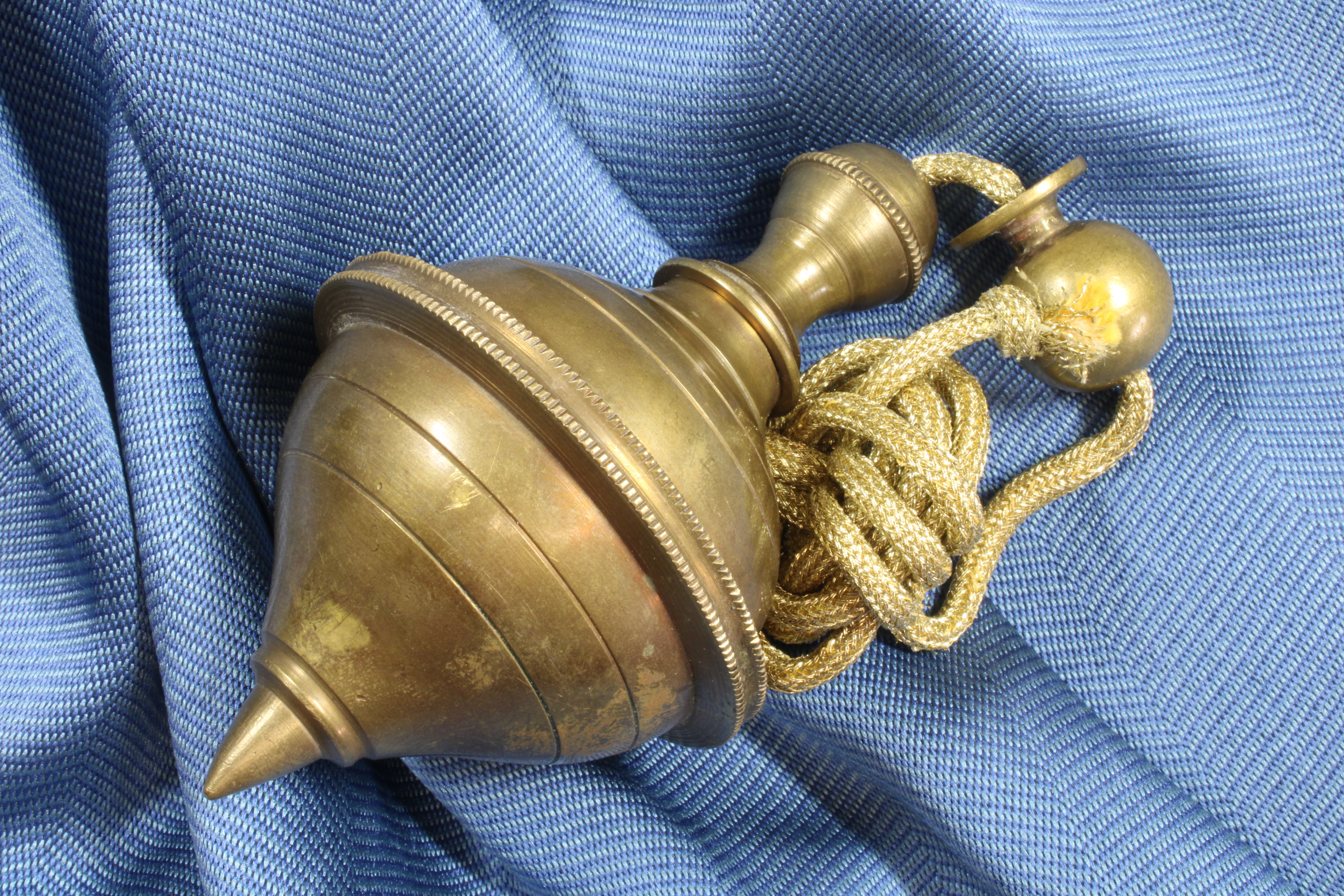 Antiques of ornamental plumb bob with walnut double cone