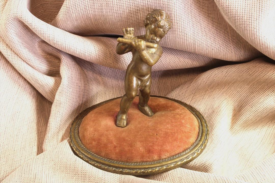 Antiques of pincushion with bronze child